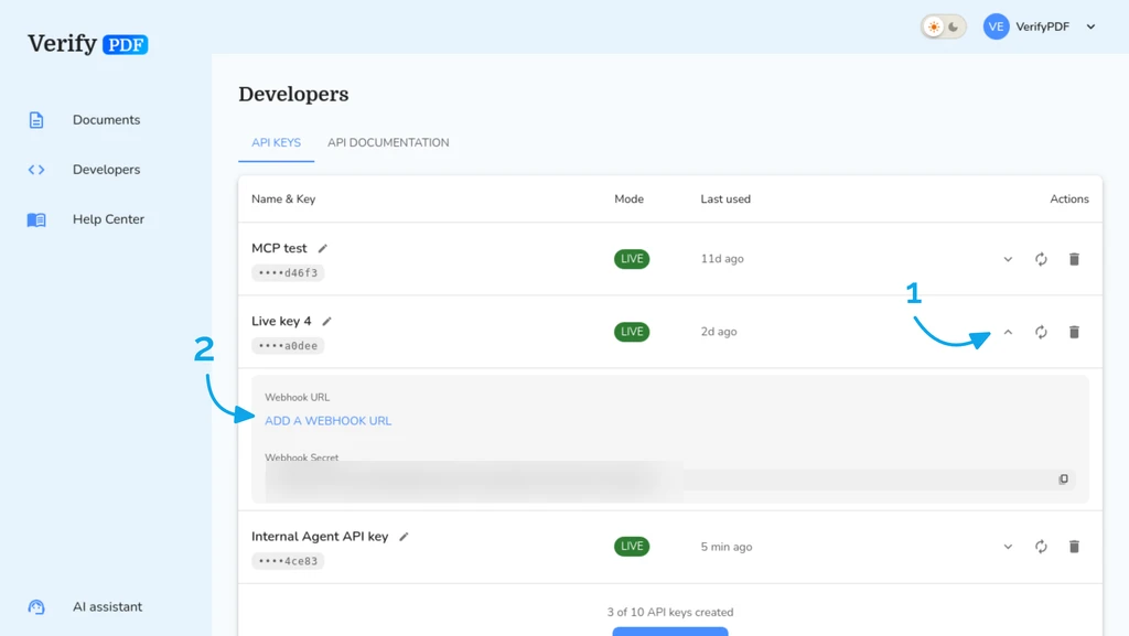 Expanding an API key reveals its webhook URL field and the webhook secret used to verify incoming calls.